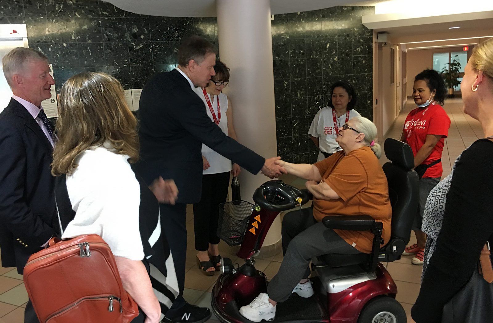 Sunnybrook CEO shaking hands with senior