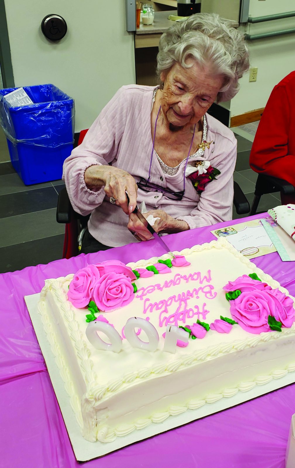 Woman cuts 100th birthday cake